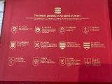 a red plaque with a list of military insignia on it