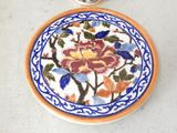a plate with a flower design on it on a table