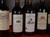 several bottles of wine are lined up on a table