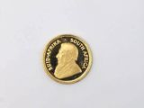 a close up of a gold coin on a white surface