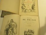 three books sitting on a table with a shadow of a person