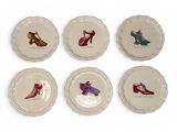 six plates with different designs of shoes on them on a white surface
