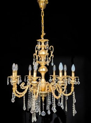 a brass and crystal chandelier with five lights