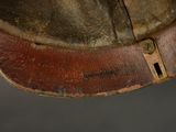 a close up of a brown hat with a leather band