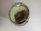 a silver hat that is sitting on a white table