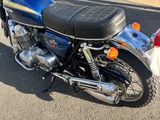 a blue motorcycle parked on the side of the road