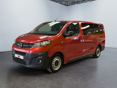 the red van is parked in a large room with a black floor
