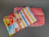 two towels are sitting on a table next to each other