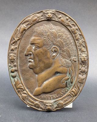a bronze plaque of a man in profile