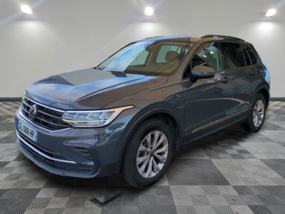 a blue volkswagen suv parked in a room with a checkered floor