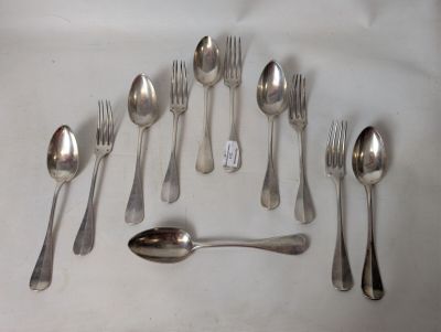 a lot of silver spoons and spoon spoons on a table