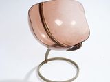 a pink glass bowl on a metal stand