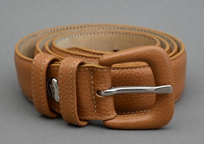 leather belt with a metal buckle on a gray surface