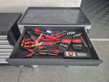 many tools in a tool box on the floor