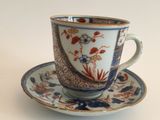 a cup and saucer with a blue and white design on it