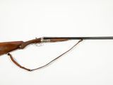 a rifle with a wooden barrel and a metal handle