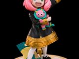 the figurine has a pink hair and is holding a stuffed animal