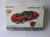 the box of a red lego car is on a white surface