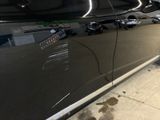 a black car with a sticker on the side of it