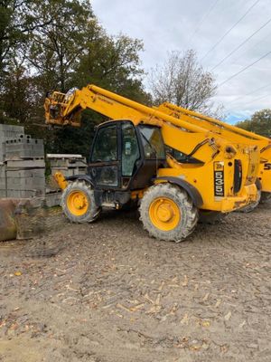 a yellow crane that is sitting in the dirt