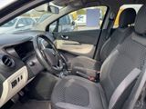 the interior of a small car with a steering wheel and dashboard