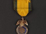 an image of a medal with a ribbon around it on a black surface