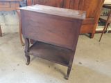 a small wooden table with a shelf on top of it