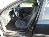 the interior of a car with the door open showing the driver ' s seat