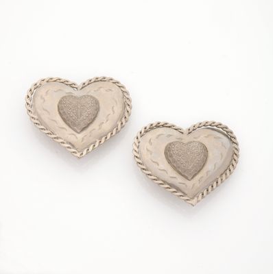 pair of silver heart shaped earrings on a white background