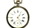 an old pocket watch with roman numerals on it
