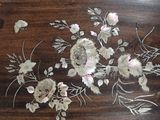 a close up of a wooden table with flowers on it