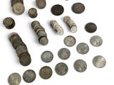 a lot of coins that are on a white surface