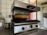 a stove with a bowl on top of it in a kitchen
