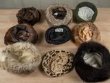 many hats that are on a wooden table