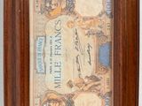 an old framed picture of a couple of people on a bank note