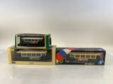 two toy trains are sitting on top of boxes on a table