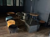 a room with a table, chairs, and a ladder in it