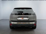 the rear view of a grey car parked in a garage