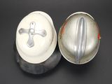 pair of antique fireman ' s helmets and a helmet on a black surface