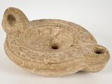 a small stone object that is sitting on a white surface