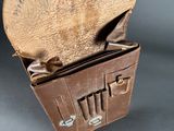 a brown leather purse with several compartments inside of it