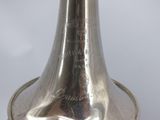 a silver bell that is sitting on a table