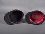 pair of black and red vases on a gray surface