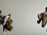 two figurines hanging from the ceiling of a room