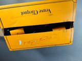 a yellow box with a bottle of champagne inside of it