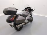 a motorcycle that is parked in a room with white walls