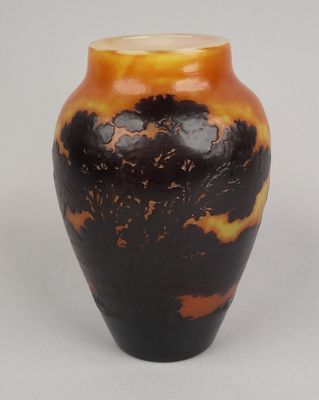 a black and orange vase sitting on a white surface