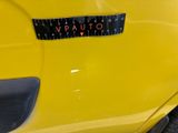 a close up of a yellow car with a logo on it