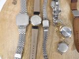 a lot of watches on a wooden board on a table