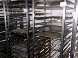 many trays of food that are on a rack